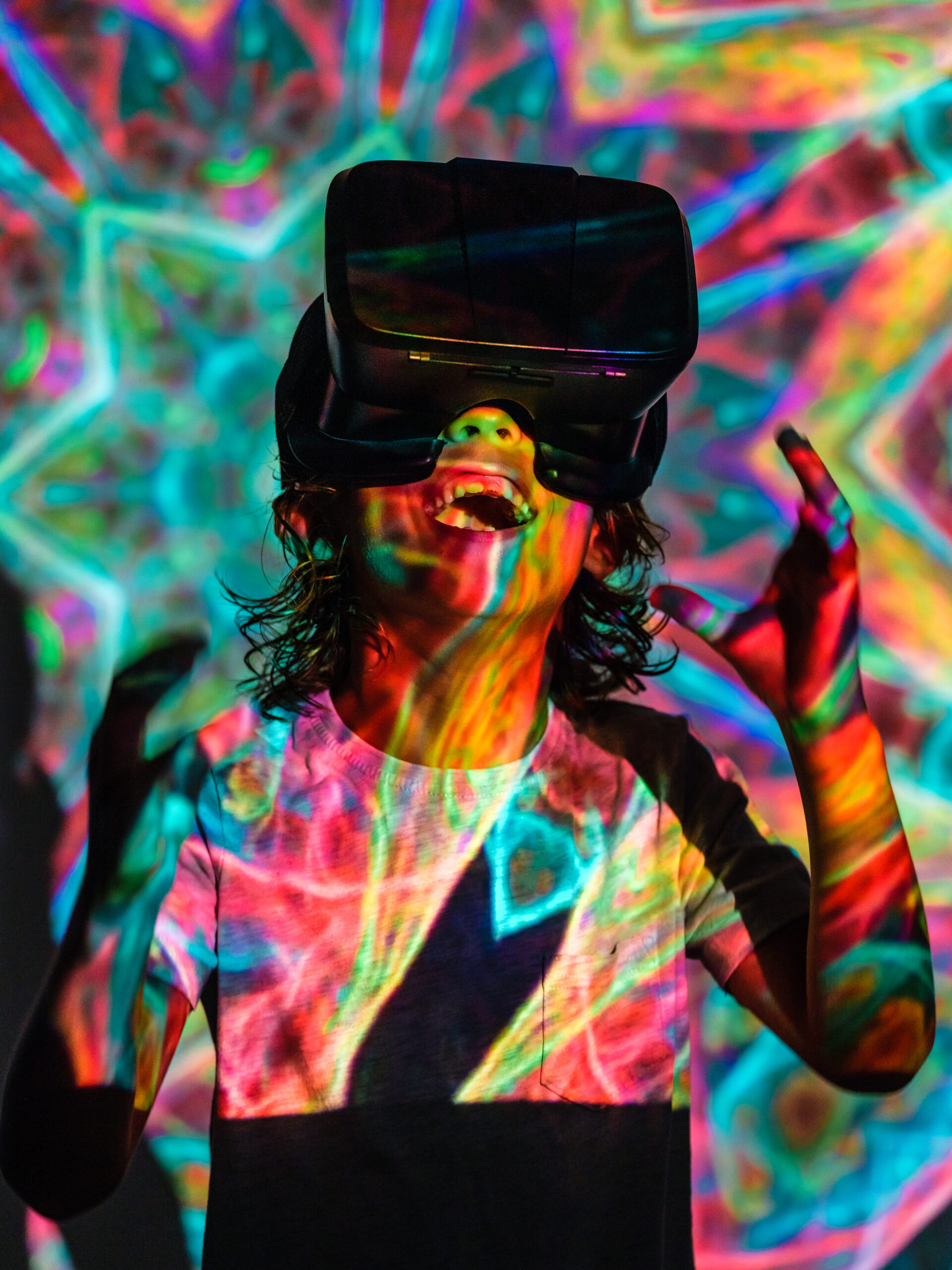 cheerful boy in vr headset in neon lights 2023 11 27 05 08 28 utc scaled